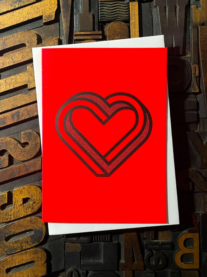 Valentine! A beautiful infinity heart monogram letterpress card printed with rich black ink on thick vibrant Gmund Action Electric Blood colourful card with a luxury matching envelope; ideal to send a to a friend or loved one.