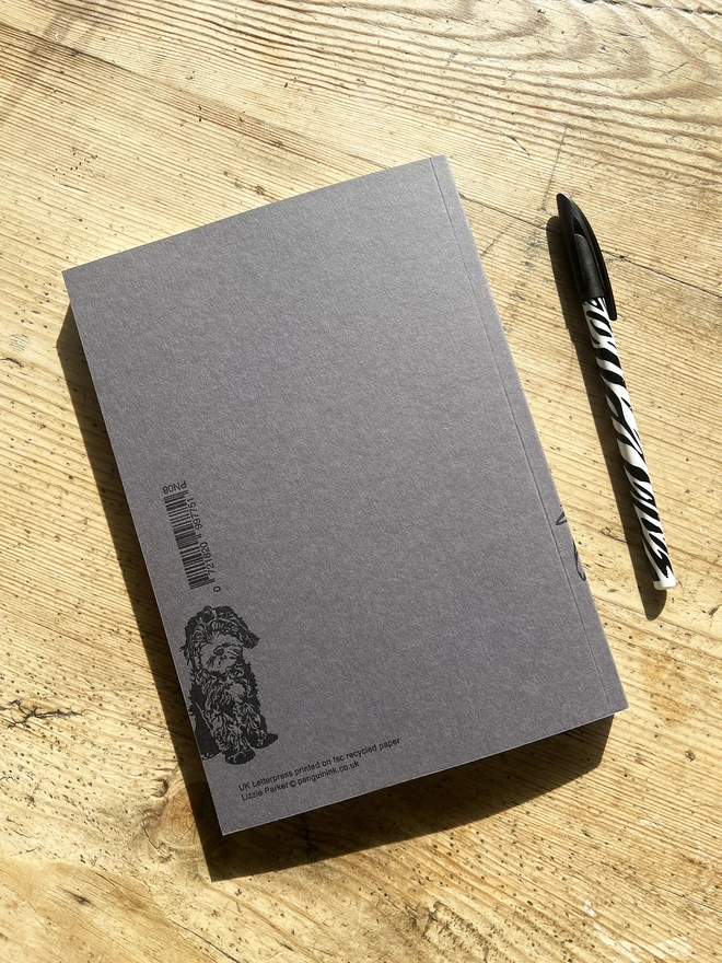 Back of the cockapoo notebook with a puppy Cockapoo sat in the bottom left hand corner.