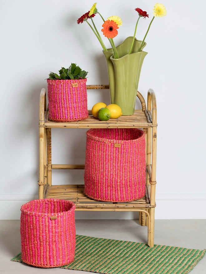 lifestyle showing pink and red pinstripe baskets