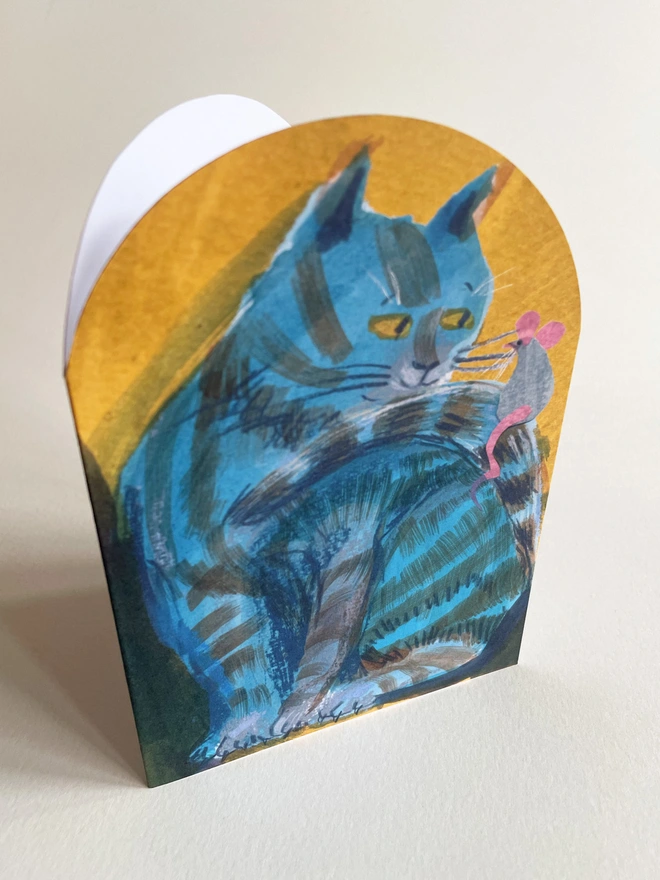 Esther Kent illustrated arch-shaped greeting card showing a blue striped cat looking at a mouse perched on its tail.