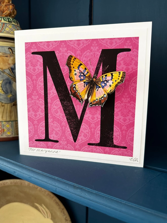 Pink initial butterflygram displayed in home