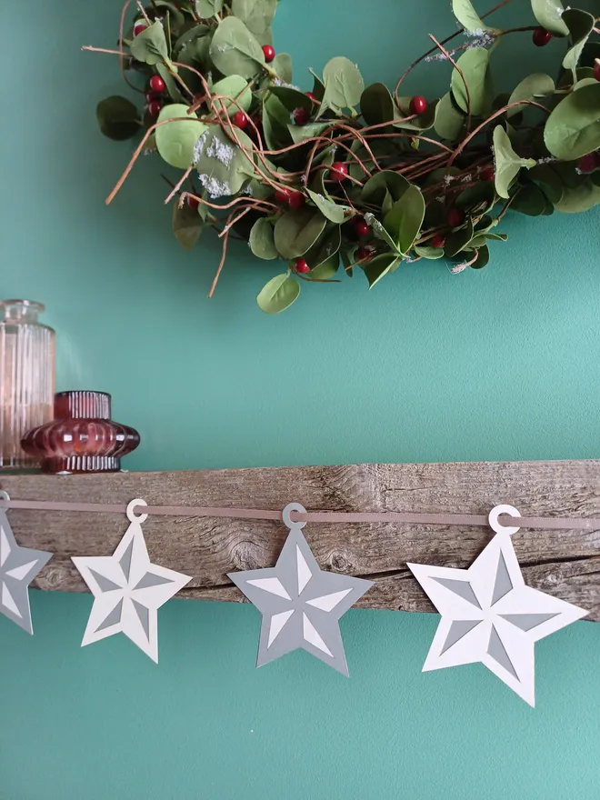 Silver and White Star Garland on Wooden MantelPiece