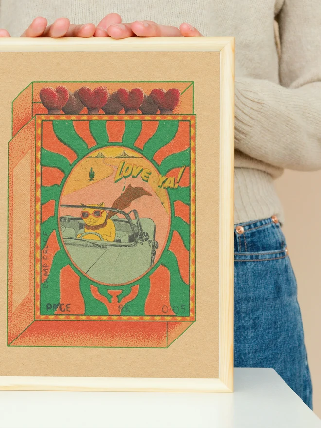 A playful burst of retro joy, Love Ya! captures a cool cat cruising through the desert in rose-tinted shades. Framed like a whimsical matchbox, the scene glows with sun-soaked oranges and greens, hand-textured grain, and heart-shaped match heads lining the top. Equal parts nostalgic and cheeky, this print blends vintage travel posters with pop surrealism—perfect for adding warmth and character to any space.  The laid-back feline, sunglasses on and paws at the wheel, radiates carefree confidence and a wink of humor. It’s a love letter to the open road, sweet moments, and saying “love ya” without taking things too seriously.  Details  High-quality art print with rich, textured color  Retro color palette with desert and sunset tones  Perfect for living rooms, studios, offices, or as a unique gift  Ships carefully packaged to protect the artwork