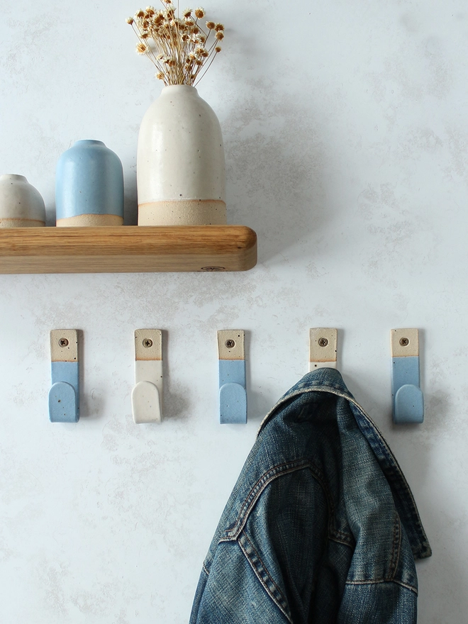 Alternating blue and white wall hooks with matching decor