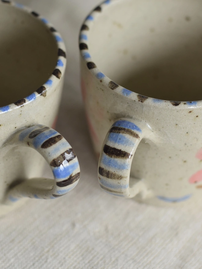 Handmade ceramic pottery mug with floral pattern