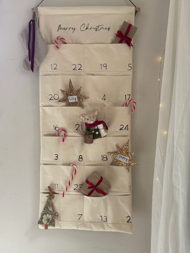 Embroidered Advent Calendar. An advent calendar filled with candy canes and other Christmas treats.