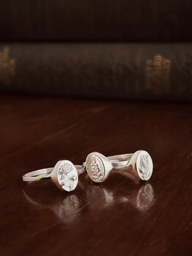 Sterling Silver Signet Rings cast with real flowers, gypsophila, fern and herb robert on a dark background