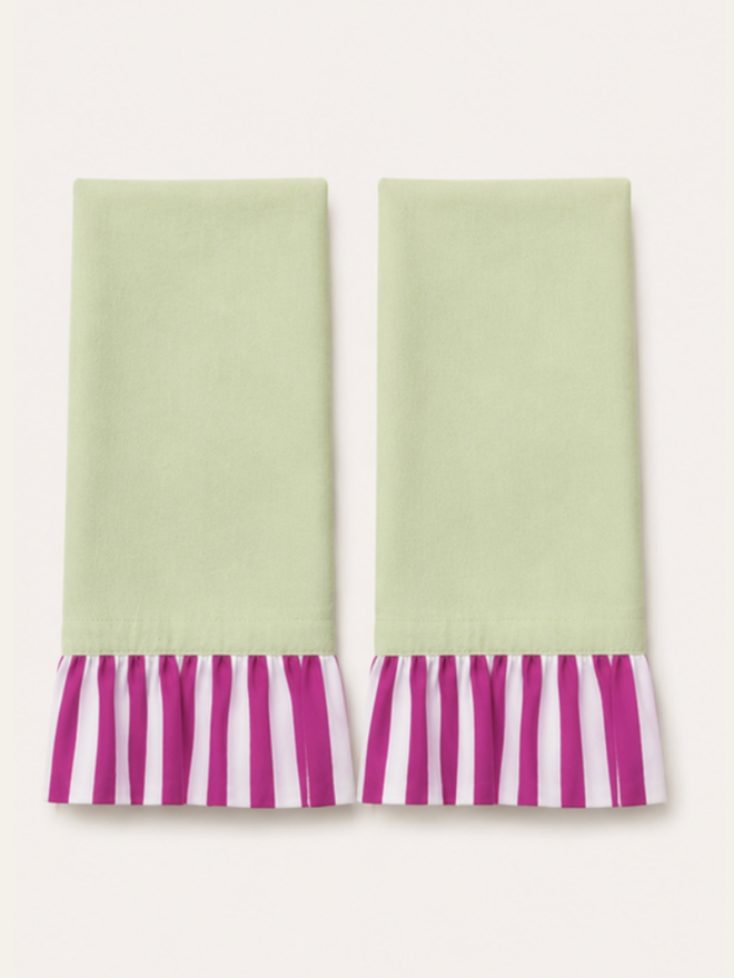 Pair of Ruffle Napkins. A pair of napkins, folded, in sage green and fuchsia.