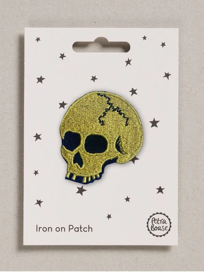 Gold skull embroidered iron on fabric patch.