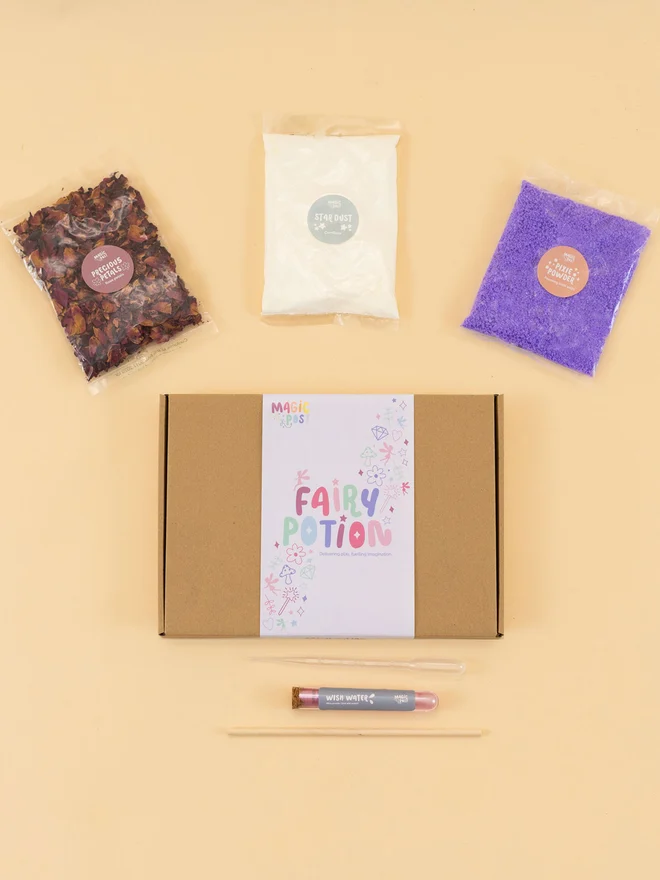 fairy mini potion kit. three bags of various sensory materials placed around a cardboard box.