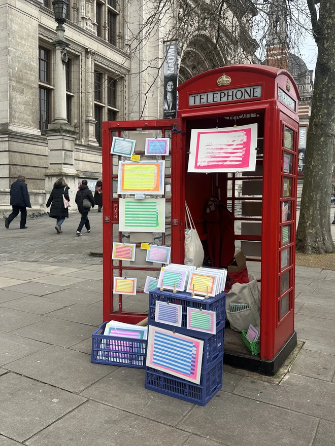 screenprint outside the V&A in red London telephone box