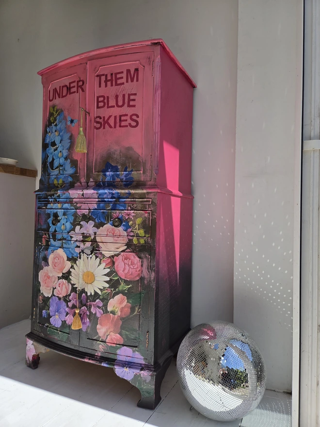 Painted vintage wooden cabinet with pink, blue and floral decoration