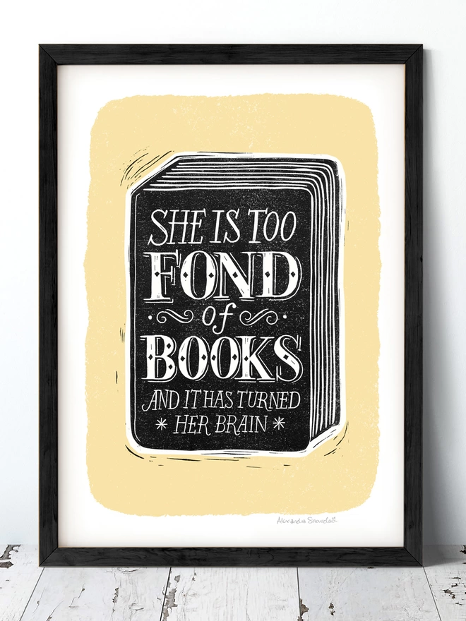 she is too fond of books reading print with black book and yellow background in a black frame