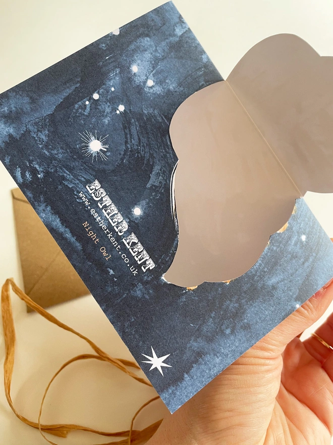 Esther Kent Night Owl illustrated greetings card reverse view shows a painterly white and brown owl on a dark blue sky. The wing folds out.