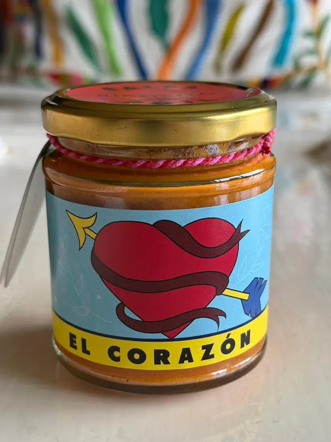 'El Corazon' Salsa Jar (Set Of 1-4 Jars), a salsa jar on a kitchen counter top. It has a red heart icon on it. 