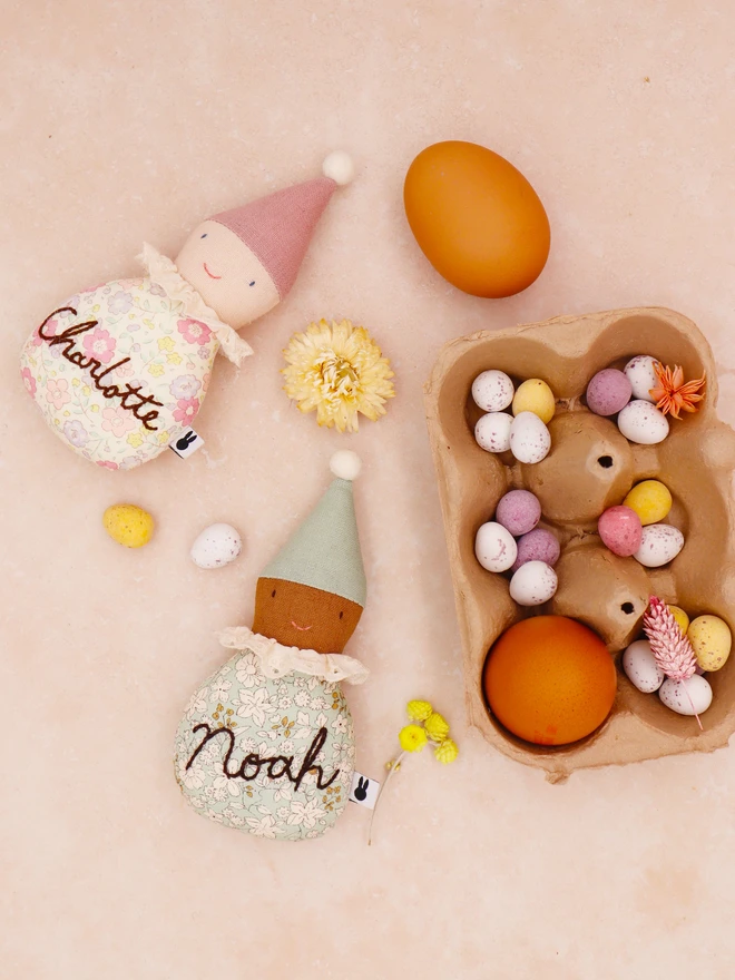 Easter egg ornaments in florla cotton body, lace frill collar and linen pointy hat in pink and blue colourways. Personalised hand emrbroidery on their bodies. 