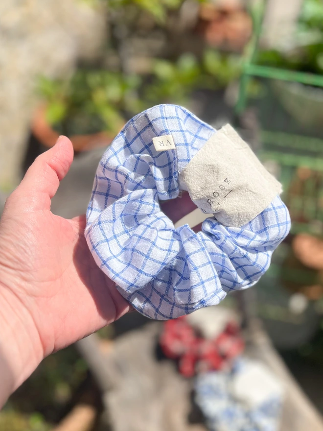 Blue linen hair scrunchie being held
