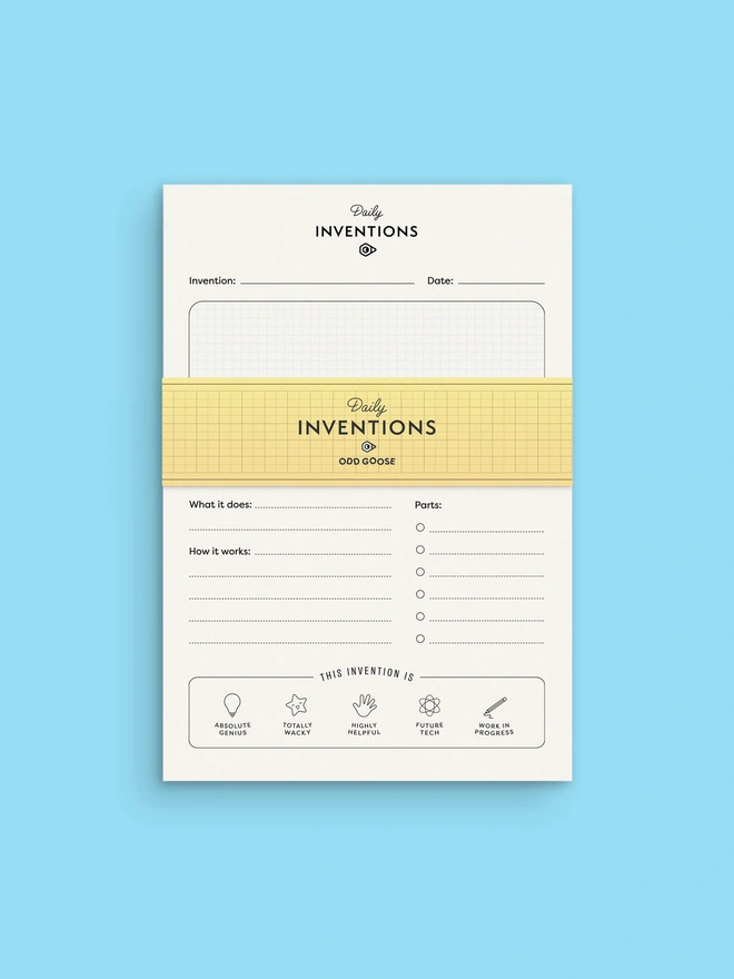 Odd Goose Daily Inventions Creative STEM notepad seen top down with yellow paper wrap on light blue background