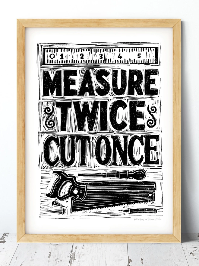 black and white measure twice cut once woodworking print in wooden frame