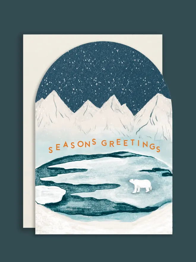 Arched shape Christmas card with white envelope, with an illustrated iceberg scene showing a polar bear under the snowy night sky