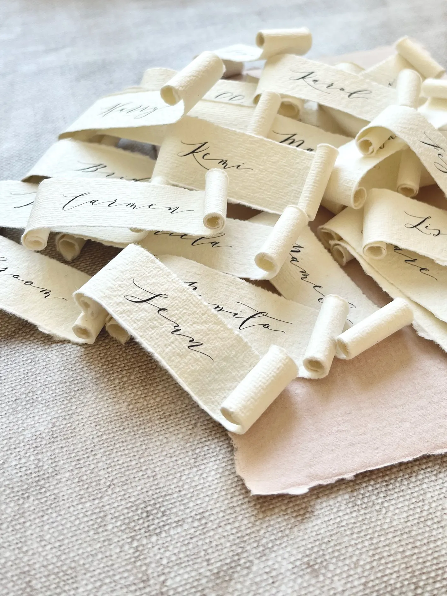 Handmade paper scroll place names with a black calligraphy font