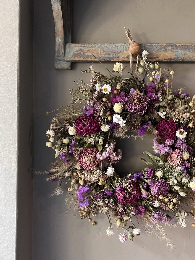 Pink and purple flower wreath made with a selection of seasonal blooms and dried dahlias. 