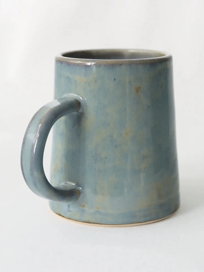 Ceramic Pint Mug, a colourful ceramic mug sitting on a white surface against a plain backdrop. 