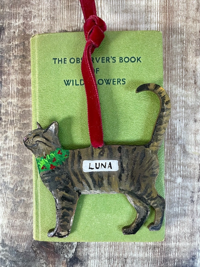 Tabby Cat Hand-painted personalised Christmas decoration with the name Luna and hung with red velvet ribbon