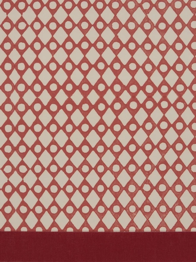 Retro Drum Lampshade. Close-up of a hand block printed lampshade showing a bold repeating geometric pattern. The colourful printed design and neat trim bring character and a handcrafted finish to any lamp.