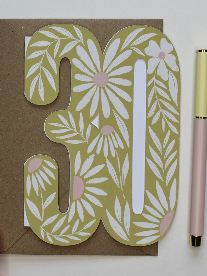 floral 30th birthday card. card shaped like 30 with illustrated daisies.
