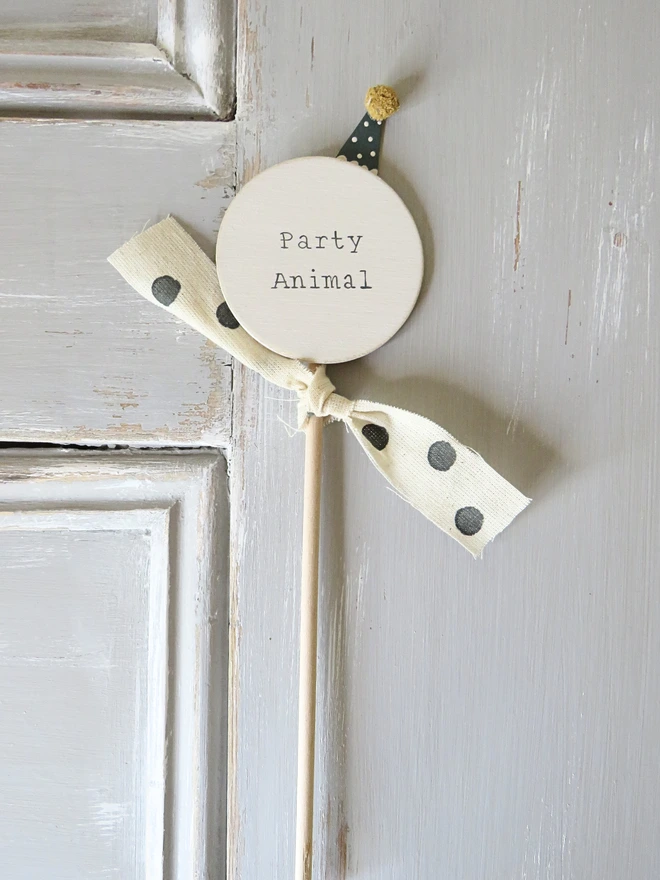 hand painted wooden cake topper with party animal message and hand made party hat