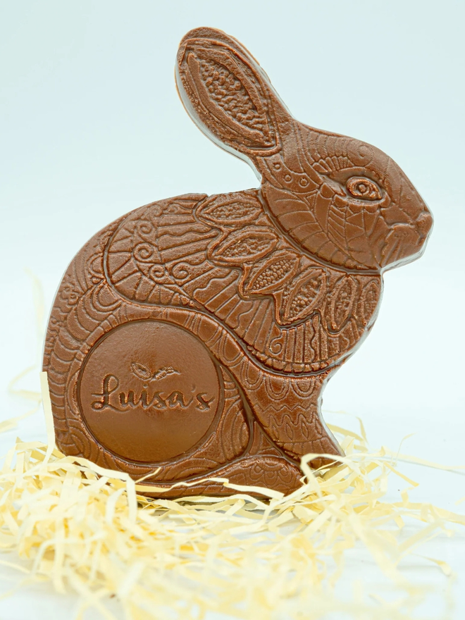 Casholate Luigi Chocolate Bunny stood up on a bed of straw