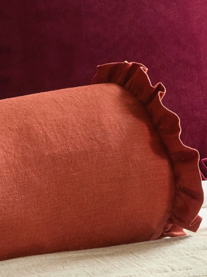 Kika Bespoke handmade rust classic linen bolster cushion close up