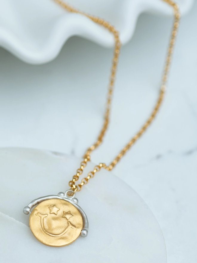 Designed for comfort and calm, the Choose Happy Spinner Necklace features a rotating mixed metal pendant with a smiley face and uplifting message. Made in sterling silver and gold plate, this spinner necklace offers soothing movement for anxious moments while adding effortless everyday style. A wearable reminder to choose happiness.  💕 