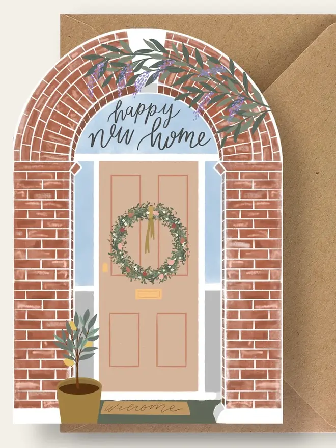 happy new home illustrated card. illustrated front of house with a wreath on the door.