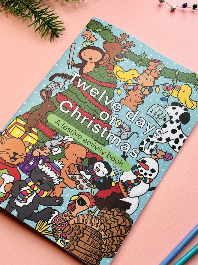 Colourful Christmas activity book cover showing playful animals celebrating the festive season.