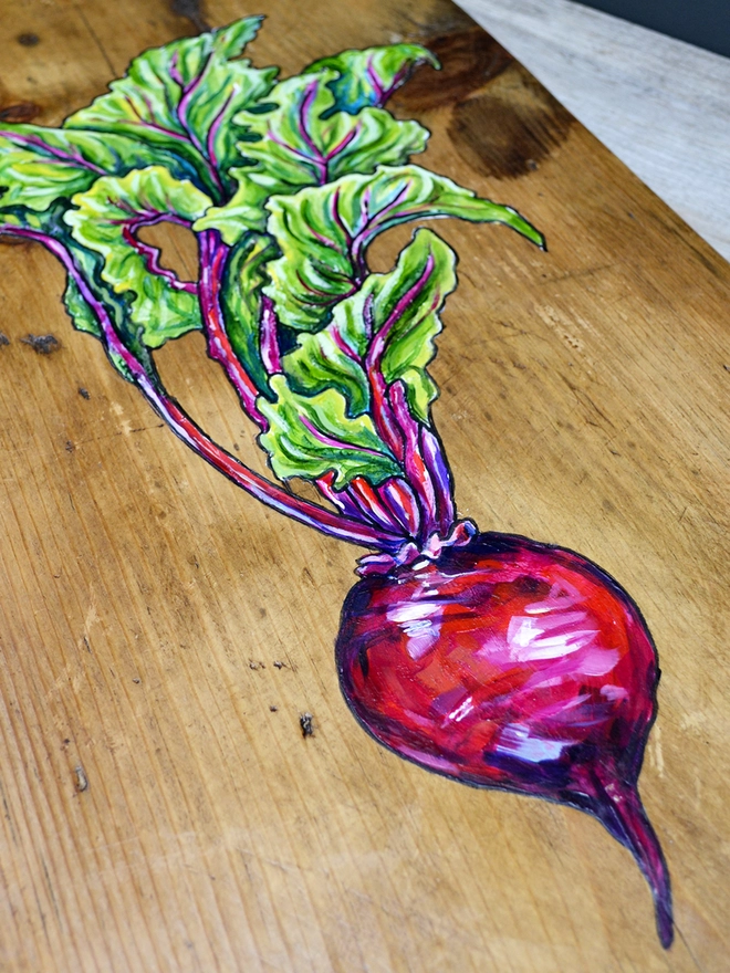 Detail of a beetroot design on a wooden serving board