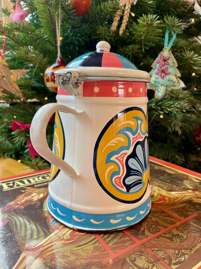 White enamel coffee pot hand painted with a fairground design in blue, pink and yellow