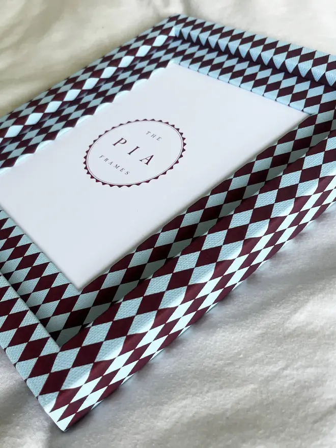Burgundy & Blue Harlequin Frame, a patterned colourful frame sitting on a plain white surface. 