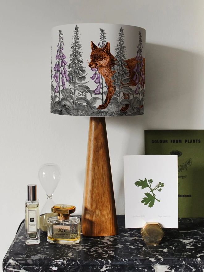 Handmade lampshade featuring a mischievous fox moving through foxglove flowers in a whimsical woodland design.
