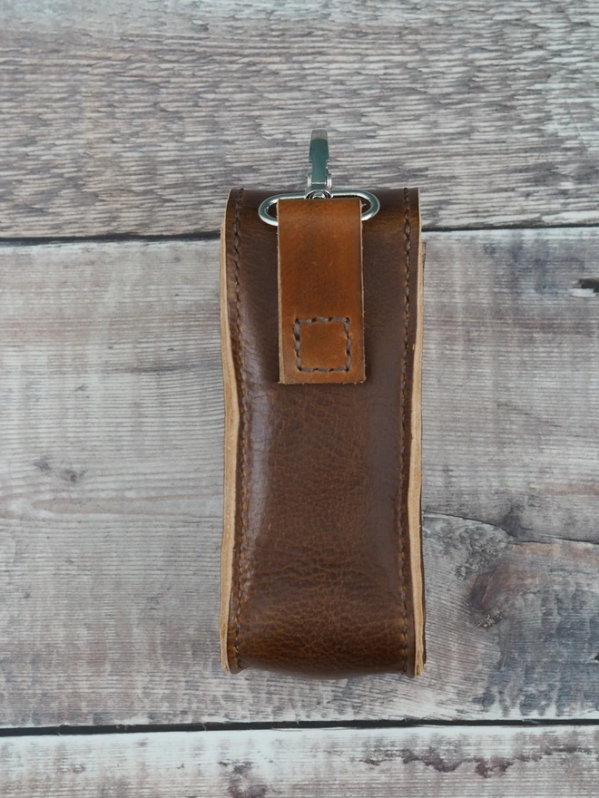 Handmade leather golf ball and tee carry case. A tan brown leather pouch that can be personalised with initials