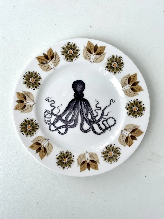 a vintage place with 60s floral browns border, and in the centre is the vintage victorian illustration of an octopus