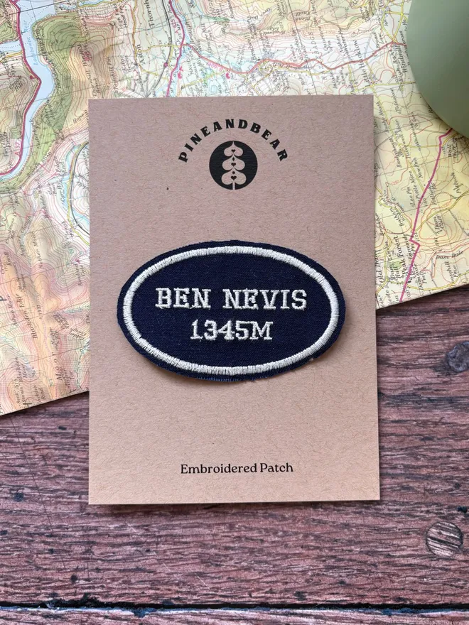Custom location patch in navy and cream with the wording Ben Nevis laying on a vintage map