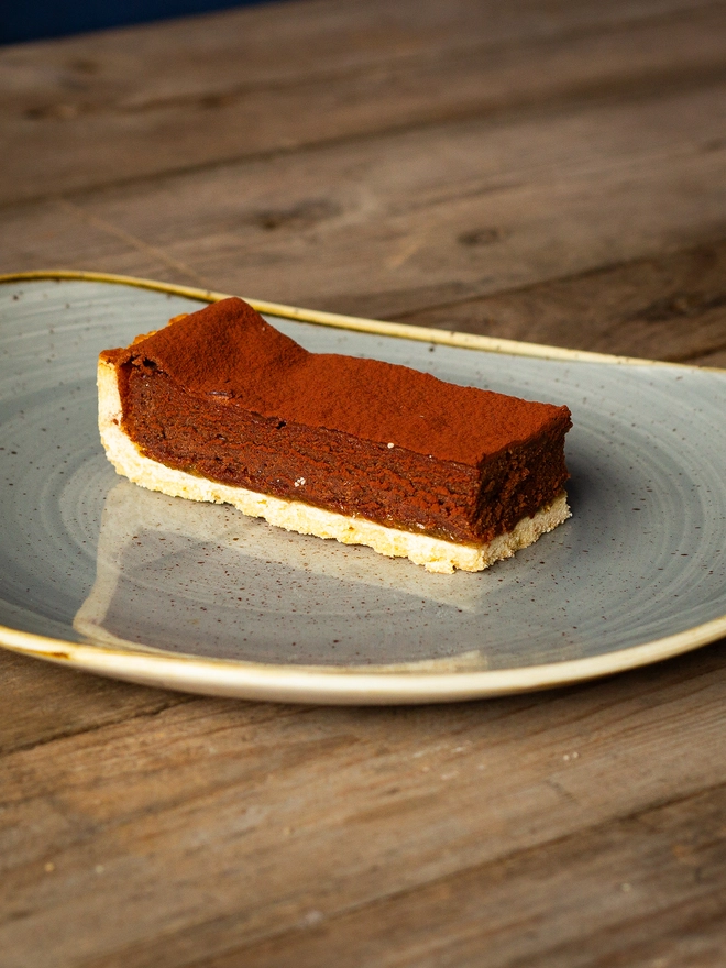 Hand-made pastry, topped with seville orange marmalade, finished with a thick chocolate filling