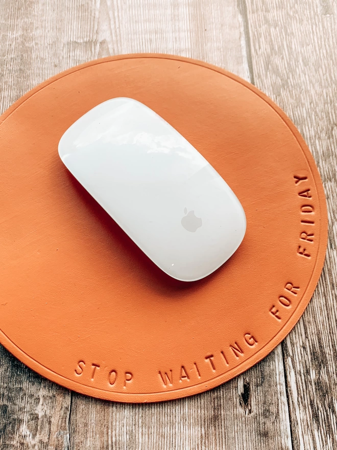 sunshine. yellow mouse mat with 'stop waiting for Friday' stamped on it.