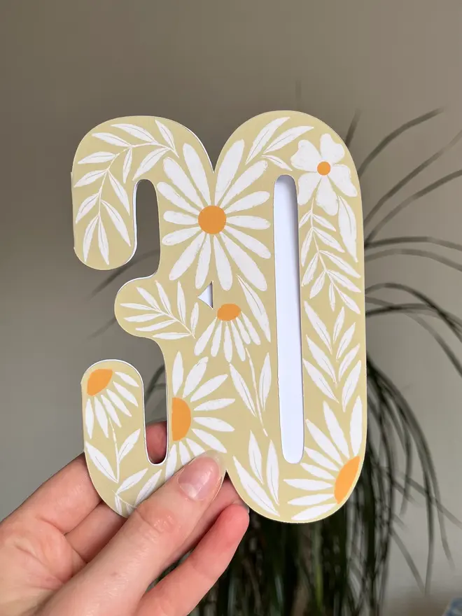 floral 30th birthday card. card shaped like 30 with illustrated daisies.