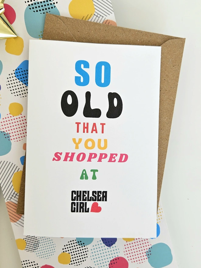 A photograph of the front of a humorous A6 greeting card illustrated using brightly coloured text and the retro shop logo. The text says so old you shopped at Chelsea Girl