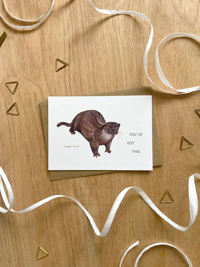 a greetings card featuring an illustration of an Otter with the text “You’ve Got This”