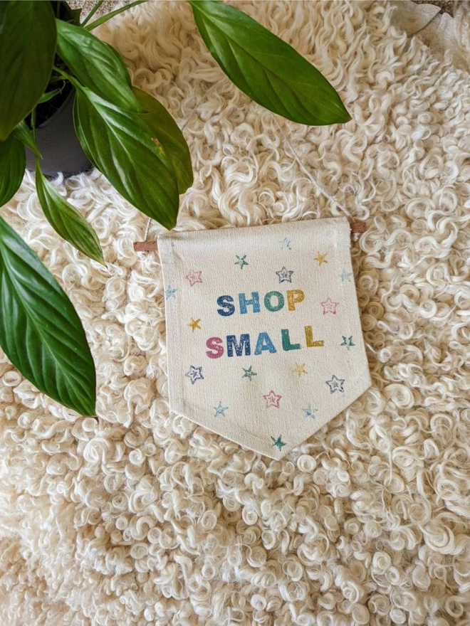 customised kids' bedroom cotton wall hanging. a banner with printed stars hanging on a bedroom wall.