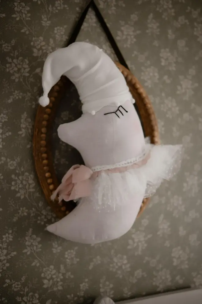 Sleepy Moon Nursery Pillow Hanging Decoration, a hanging pillow decoration suspended in a bedroom. 